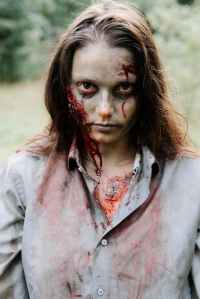 A female zombie stares hungrily